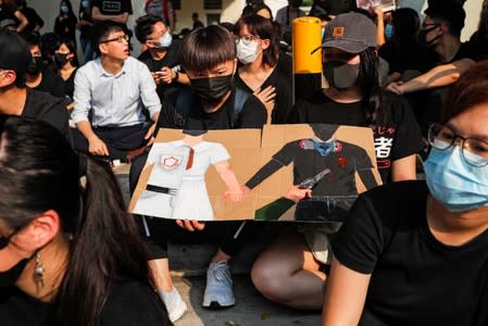 Alumnus of Tsuen Wan Public Ho Chuen Yiu Memorial College participate in a student gathering in the school in solidarity with the student protester who was shot by a policeman on Tuesday in Tsuen Wan, Hong Kong