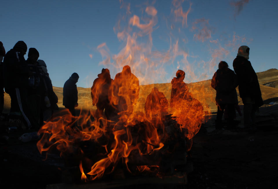 AP10ThingsToSee - People burn offerings to "Pachamama," or "Mother Earth," and ask for good fortune on La Cumbre, a mountain that is considered sacred ground, on the outskirts of La Paz, Bolivia, Friday, Aug. 1, 2014. (AP Photo/Juan Karita)