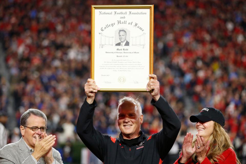 Former Georgia football Mark Richt is honer with his College Football hall of fame plaque during the first half of a NCAA college football game against Ole Miss in Athens, Ga., on Saturday, Nov. 11, 2023.