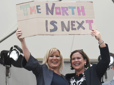 Sinn Fein leader Mary Lou McDonald and Michelle O'Neill leader of Sinn Fein in Northern Ireland hold up a placard as they celebrate the result of yesterday's referendum on liberalizing abortion law, in Dublin, Ireland, May 26, 2018. REUTERS/Clodagh Kilcoyne