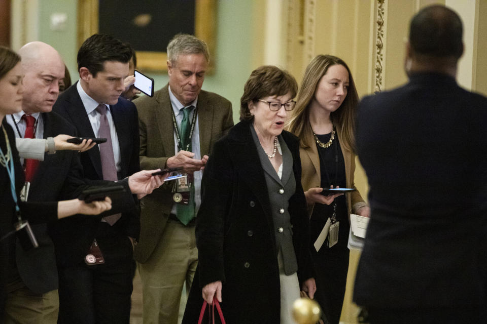 Sen. Susan Collins (R-Maine) is trailed by reporters as she arrives Thursday before the Senate impeachment trial. Collins announced late Thursday that she favors allowing witnesses. (Photo: Samuel Corum via Getty Images)