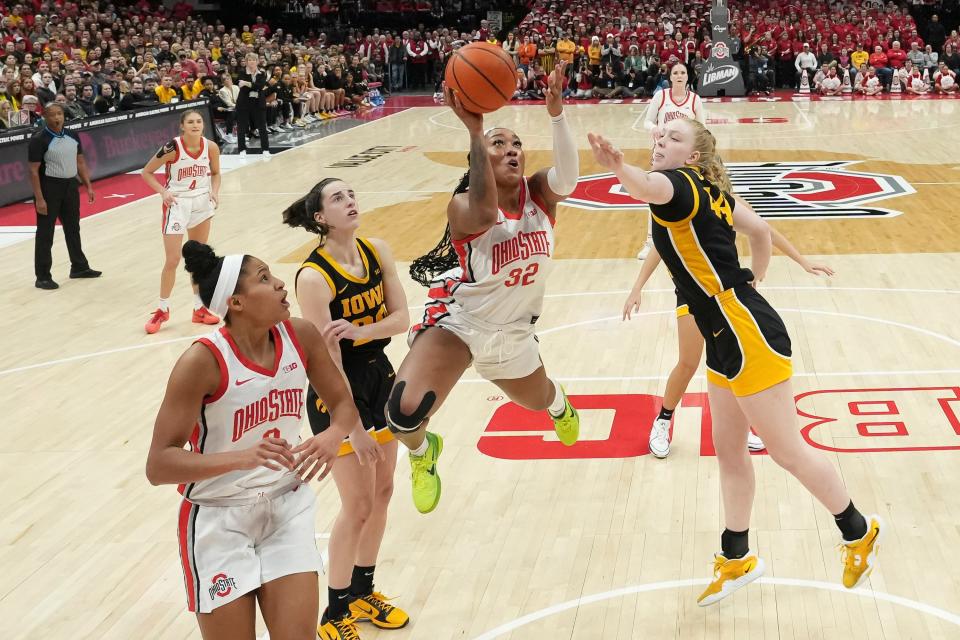 Ohio State forward Cotie McMahon makes a shot between Iowa's Caitlin Clark (22) and Addison O'Grady on Sunday.