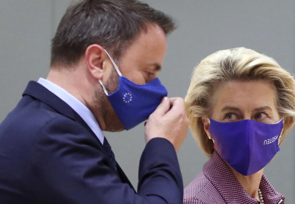 Luxembourg's Prime Minister Xavier Bettel, left, speaks with European Commission President Ursula von der Leyen during a round table meeting at an EU summit at the European Council building in Brussels, Thursday, Oct. 15, 2020. European Union leaders are meeting in person for a two-day summit amid the worsening coronavirus pandemic to discuss topics ranging from Brexit to climate and relations with Africa. (Yves Herman, Pool via AP)