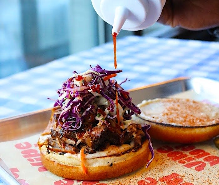 A pulled pork sandwich is plated at Vibe BBQ.