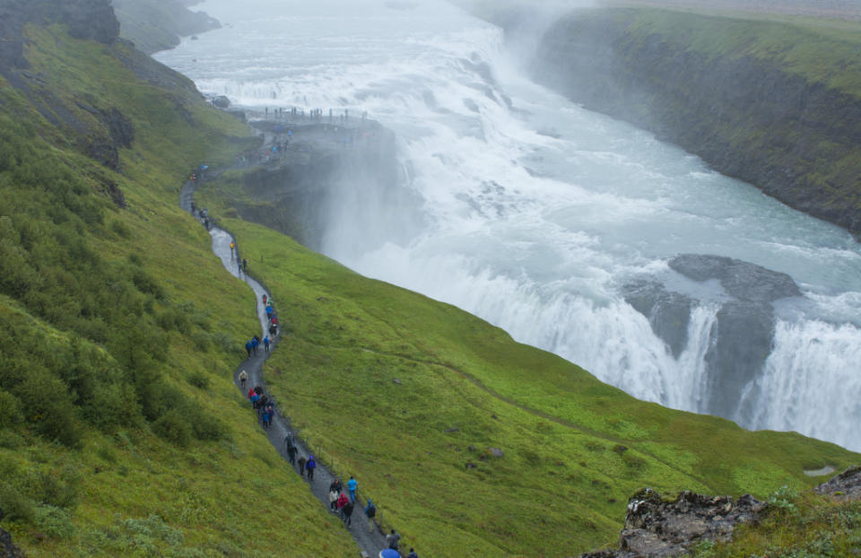 Iceland Gullfoss Falls on Hvita River from above with tourists walking on trail