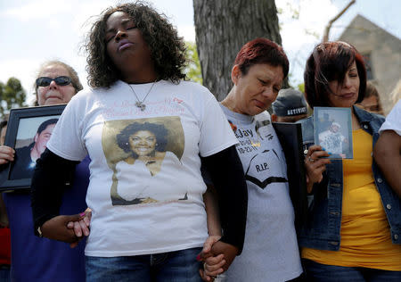 FILE PHOTO: Nortasha Stingiey (2nd L) hold hands in a group prayer during a news conference by "Purpose over Pain", a group of mothers who lost children to gun violence, calling for a stop to shootings in Chicago, Illinois, United States, May 6, 2016. REUTERS/Jim Young/File Photo