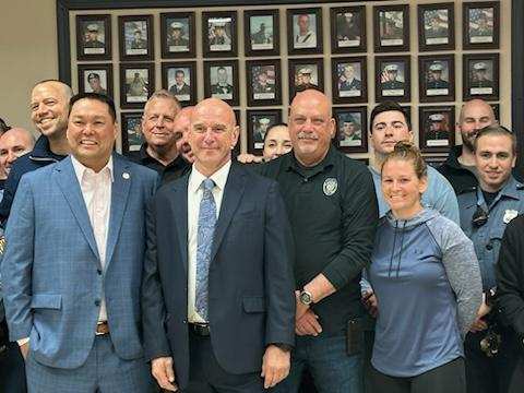 Police Sgt. Joseph Candido, center, poses with members of the Jackson Police Department after being named the township's public safety director on April 10, 2024.