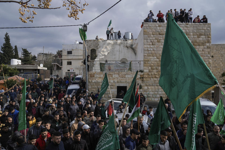 Palestinian demonstrators wave Hamas and their national flags during a protest against the killing of top Hamas official Saleh Arouri in Beirut, in the West Bank town of Arura, on Friday, Jan. 5, 2024. Arouri, the No. 2 figure in Hamas, was killed in an explosion blamed on Israel. He is the highest-ranked Hamas figure to be killed in the nearly three-month war between Israel and Hamas. (AP Photo/Majdi Mohammed)