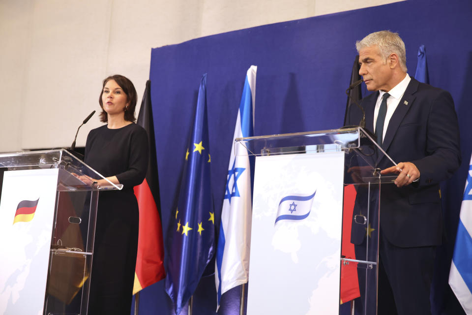 German Foreign Minister Annalena Baerbock and Israeli Foreign Minister Yair Lapid talk during a joint press conference in Tel Aviv, Israel, Thursday, Feb. 10, 2022. (AP Photo/Oren Ziv)