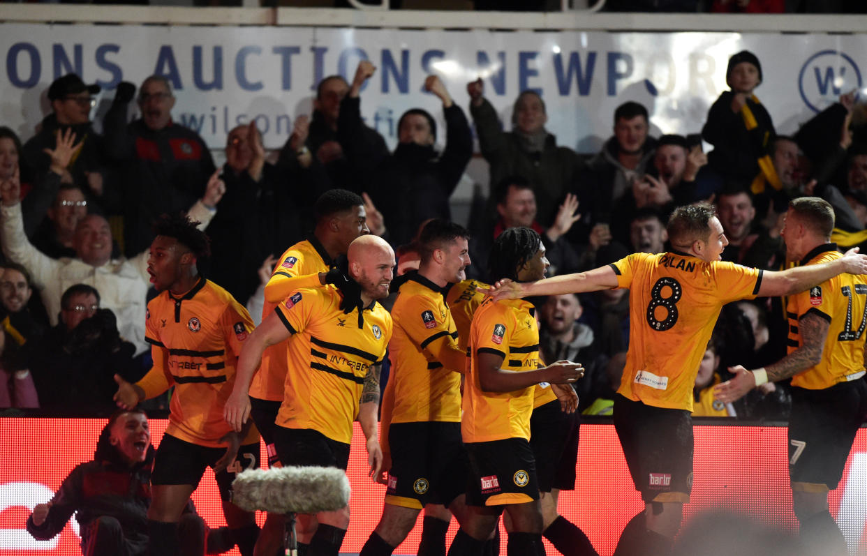 Newport County players and fans celebrate their winning goal against former English Premier League champions Leicester City. (PHOTO: Reuters/Rebecca Naden)