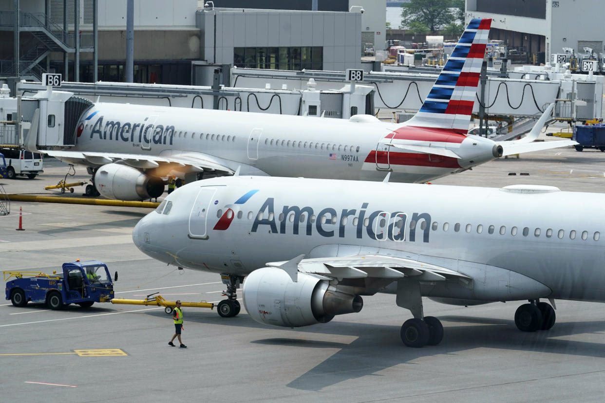 American Airlines passenger jets prepare for departure on July 21, 2021, near a terminal at Boston Logan International Airport. (Steven Senne / AP file)