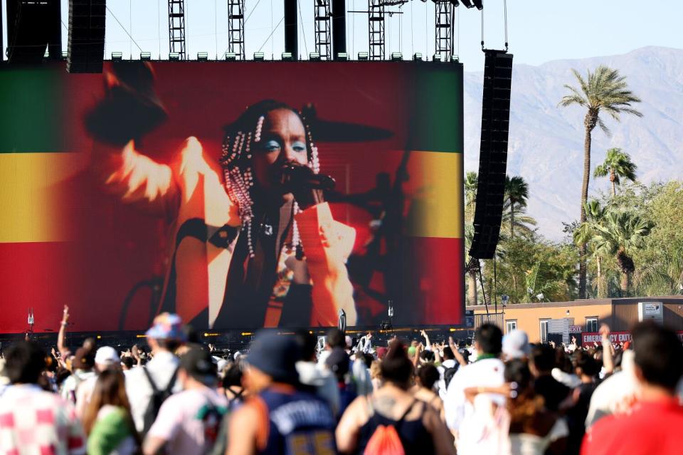 Large screen shows a person singing on stage