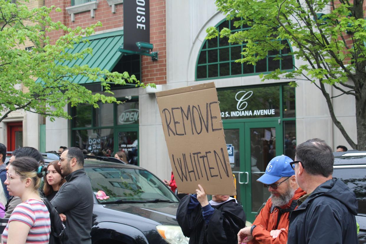 A protester holds up a sign calling for the termination of Indiana University President Pamela Whitten during a protest outside of Bryan Hall on Monday, April 29.