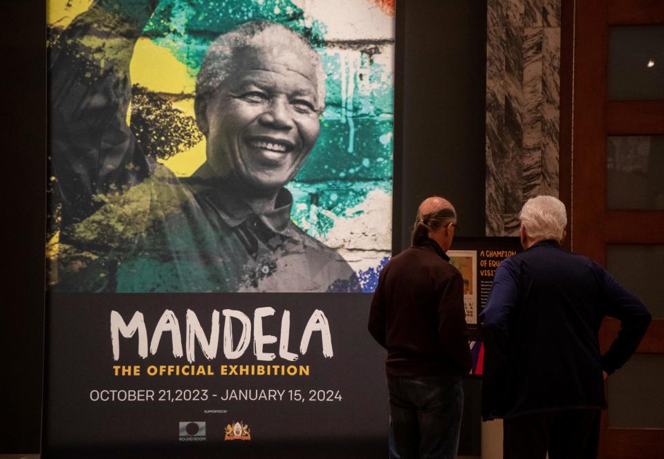 Two people read about the new Nelson Mandela the Official Exhibition inside the Henry Ford Museum of American Innovation?in Dearborn on Thursday, Oct. 19, 2023. The exhibit will be from Oct. 21, 2023, to Jan. 15, 2024.