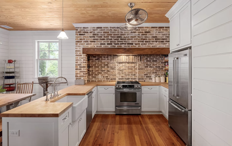 The kitchen has top of the line appliances and an eating area.