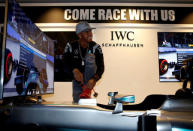 Mercedes' Lewis Hamilton of Britain laces his shoe at a driving simulator at a publicity event ahead of the Singapore F1 Grand Prix Night Race in Singapore September 14, 2016. REUTERS/Edgar Su