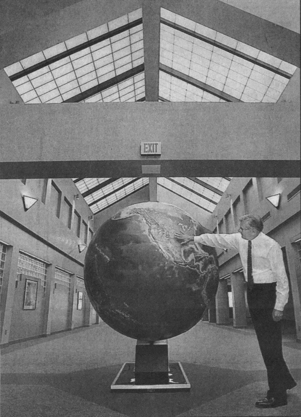 Eros Chief Don Lauer photographed in 1996 by the globe installed in the lobby in 1983.