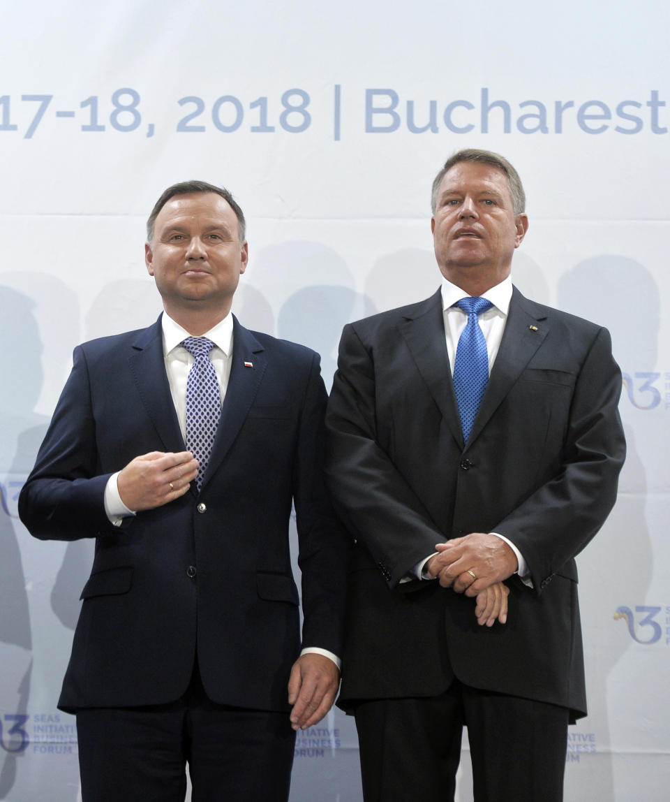 Polish President Andrzej Duda, left, poses next to Romanian counterpart Klaus Iohannis at the opening of the Three Seas Initiative in Bucharest, Romania, Monday, Sept. 17, 2018. U.S. President Donald Trump has reaffirmed Washington's support for a business summit that aims to boost connectivity in Eastern Europe and improve ties between the region and the U.S. and European Union.(AP Photo/Andreea Alexandru)