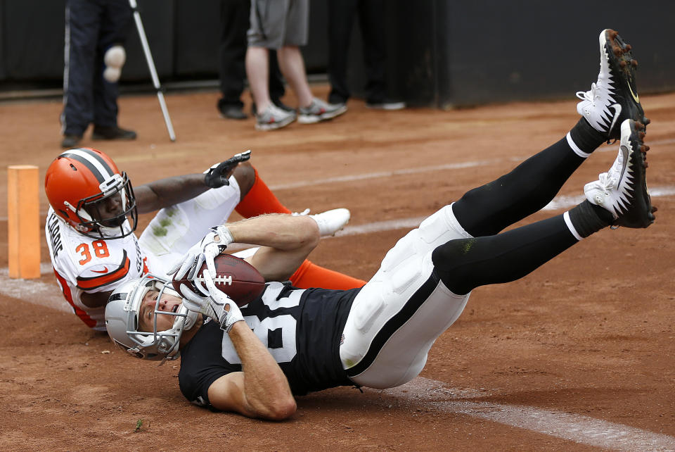 Oakland Raiders wide receiver Jordy Nelson, bottom, converts a two point conversion in front of Cleveland Browns defensive back T.J. Carrie (38) during the second half of an NFL football game in Oakland, Calif., Sunday, Sept. 30, 2018. (AP Photo/D. Ross Cameron)