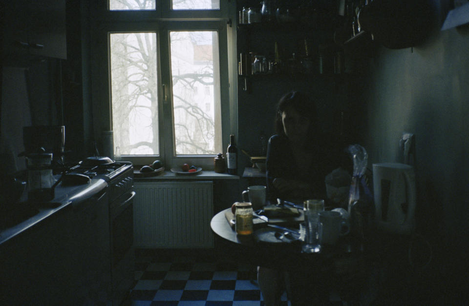 Woman in dark kitchen