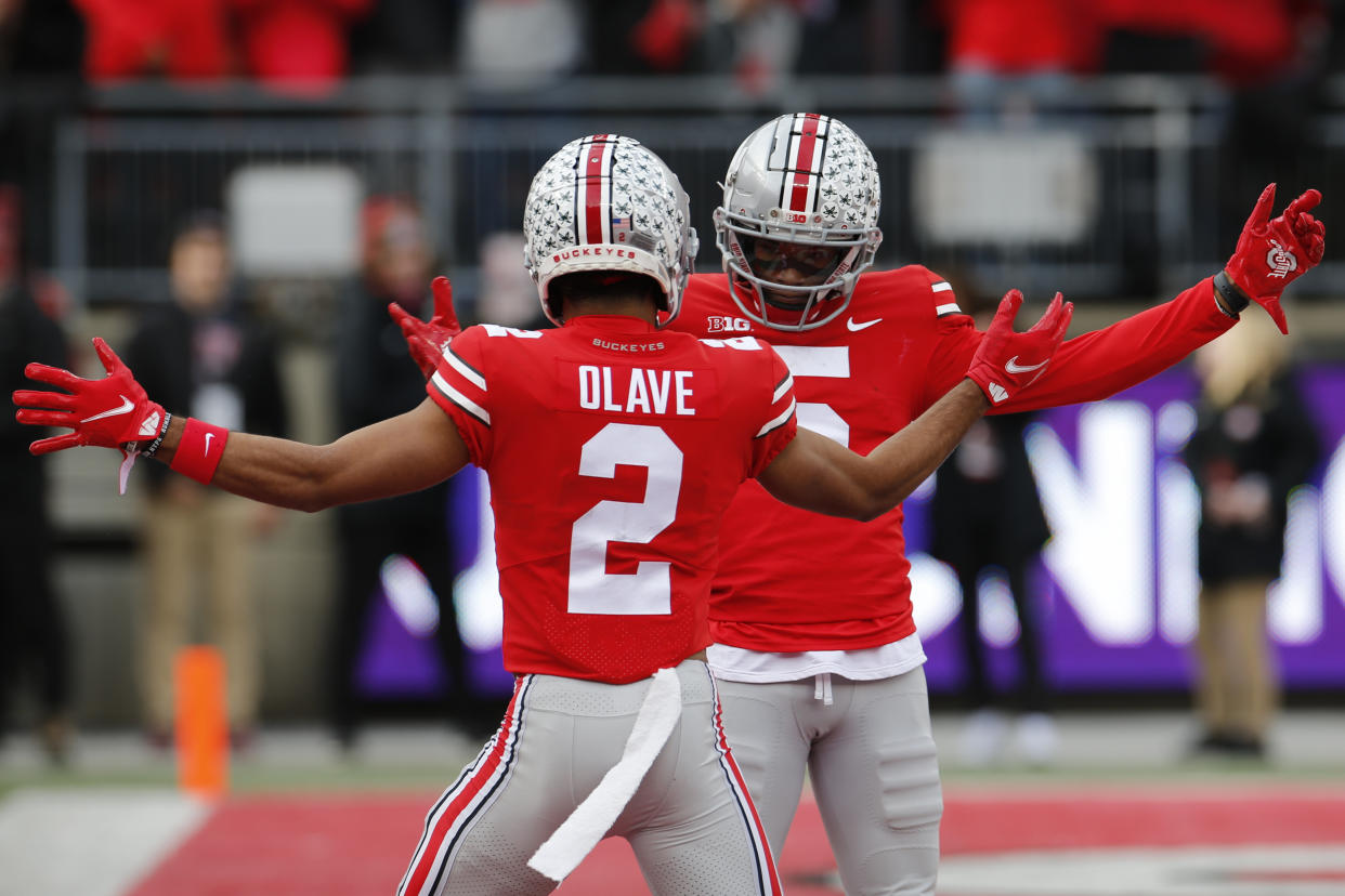Ohio State receiver Garrett Wilson, right, celebrates his touchdown against Michigan State with teammate Chris Olave during the first half of an NCAA college football game Saturday, Nov. 20, 2021, in Columbus, Ohio. (AP Photo/Jay LaPrete)