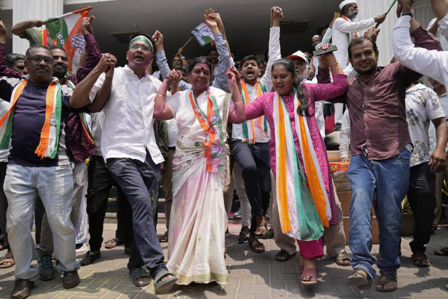 Supporters of opposition Congress party dance to celebrate early leads for the party in the Karnataka state elections in Bengaluru, India, Saturday, May 13, 2023. Elections in India's southern state of Karnataka were held on May 10. (AP Photo/Aijaz Rahi)
