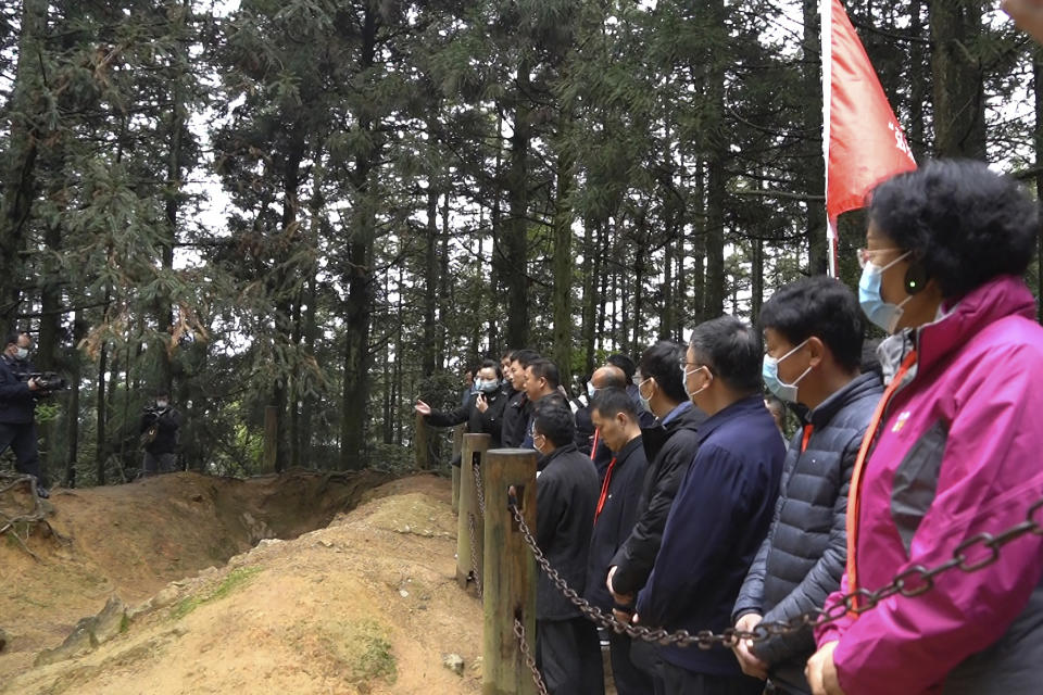 Students at the China Executive Leadership Academy listen to a field lecture in front of revolutionary wartime trenches of the late 1920s in JInggangshan in southeastern China's Jiangxi Province, on April 9, 2021. As China celebrates the 100th anniversary of its 1921 founding, such trainings are part of efforts by President Xi Jinping's government to extend party control over a changing society. (AP Photo/Emily Wang)