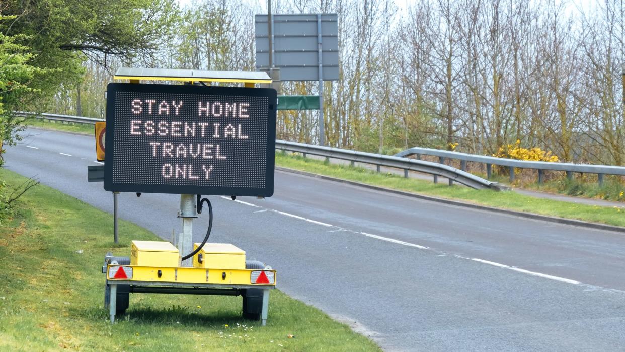 Road sign indicating essential travel only due to the Covid-19 lockdown