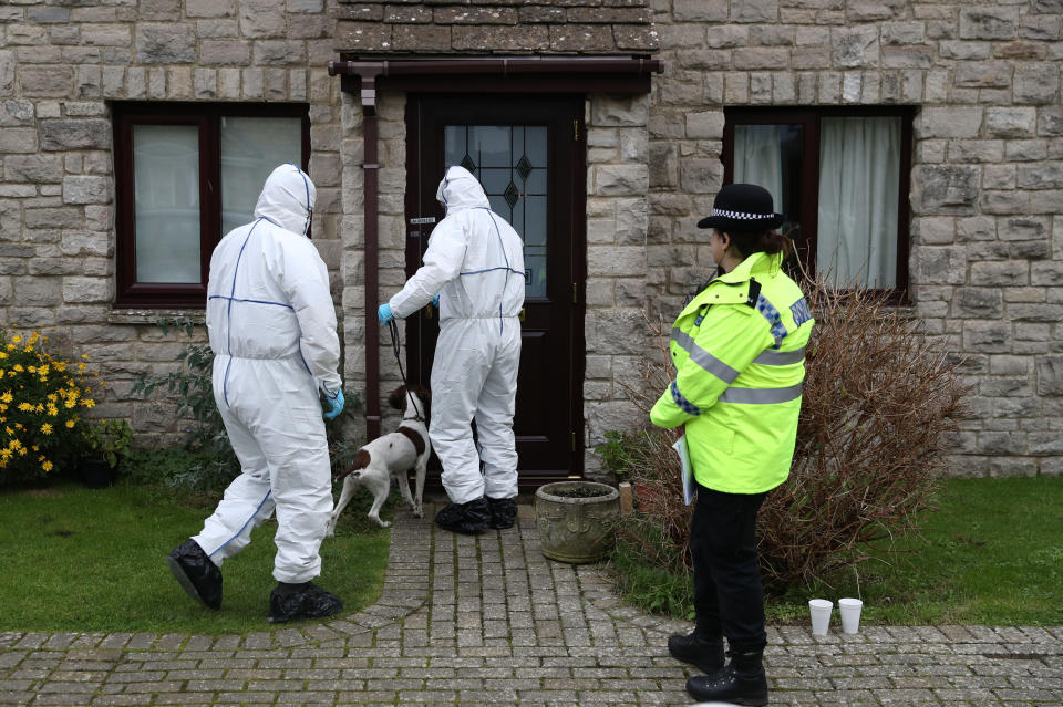 Forensic teams investigate the home where she was last seen (Picture: PA)