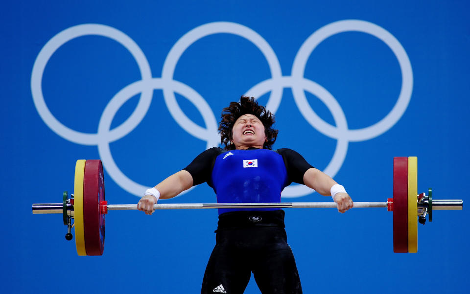 LONDON, ENGLAND - AUGUST 01: Yura Mun of Korea competes in the Women's 69kg Weightlifting on Day 5 of the London 2012 Olympic Games at ExCeL on August 1, 2012 in London, England. (Photo by Laurence Griffiths/Getty Images)