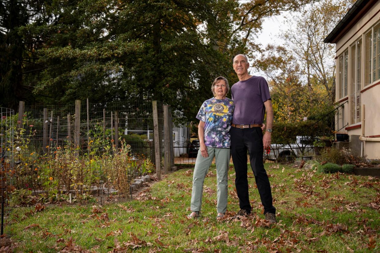 Sharon and Jeff Gustin stand for a portrait in their backyard. The Gustins participate in Project FeederWatch, a November to April survey of backyard birds.