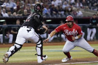 Cincinnati Reds' Christian Encarnacion-Strand (33) gets caught in a rundown as Arizona Diamondbacks catcher Jose Herrera, left, gets set to make the tag during the 10th inning of a baseball game Saturday, Aug. 26, 2023, in Phoenix. The Reds won 8-7 in 11 innings. (AP Photo/Ross D. Franklin)