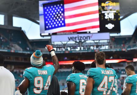 Aug 9, 2018; Miami Gardens, FL, USA; Miami Dolphins defensive end Robert Quinn (94) raises his fist during the national anthem prior to the game against the Tampa Bay Buccaneers during the first half at Hard Rock Stadium. Jasen Vinlove-USA TODAY Sports