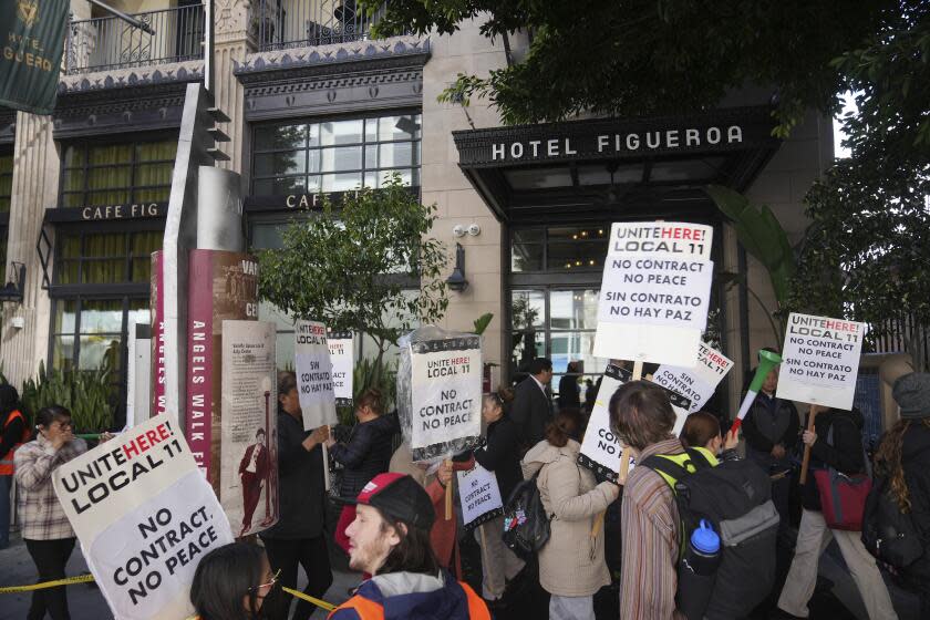 Unite Here Local 11 workers hold a rally as they protest outside the Figueroa Hotel in downtown Los Angeles on Friday, April 5, 2024. (AP Photo/Damian Dovarganes)