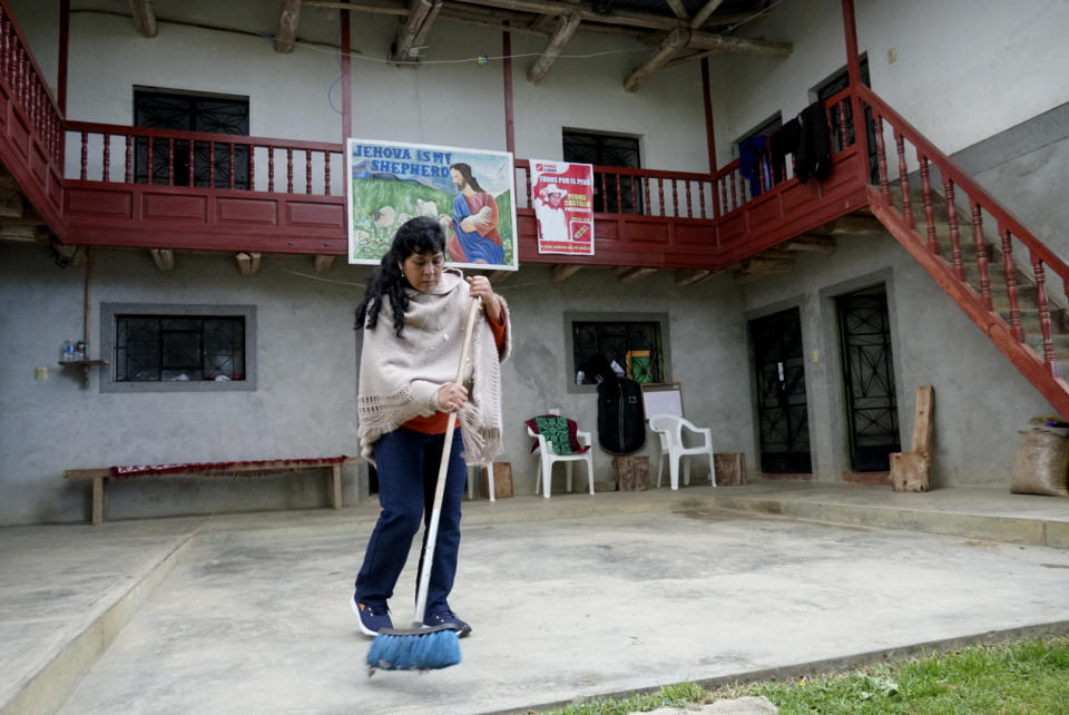 The future first lady of Peru, Lilia Paredes, 48, sweeps the courtyard of her adobe house in the rural hamlet of Chugur, Peru, Thursday, July 22, 2021. Her husband, leftist Pedro Castillo catapulted from unknown to president-elect with the support of the country's poor and rural citizens, many of whom identify with the struggles the teacher has faced. (AP Photo/Franklin Briceno)