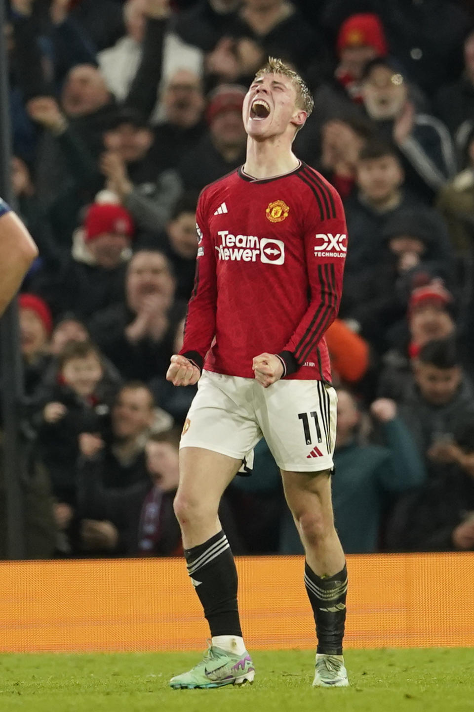 Manchester United's Rasmus Hojlund celebrates after scoring his side's third goal during the English Premier League soccer match between Manchester United and Aston Villa at the Old Trafford stadium in Manchester, England, Tuesday, Dec. 26, 2023. (AP Photo/Dave Thompson)