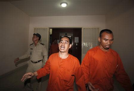 People convicted of plotting to overthrow the Cambodian government walk out after being sentenced at the Phnom Penh Municipal Court April 11, 2014. REUTERS/Samrang Pring