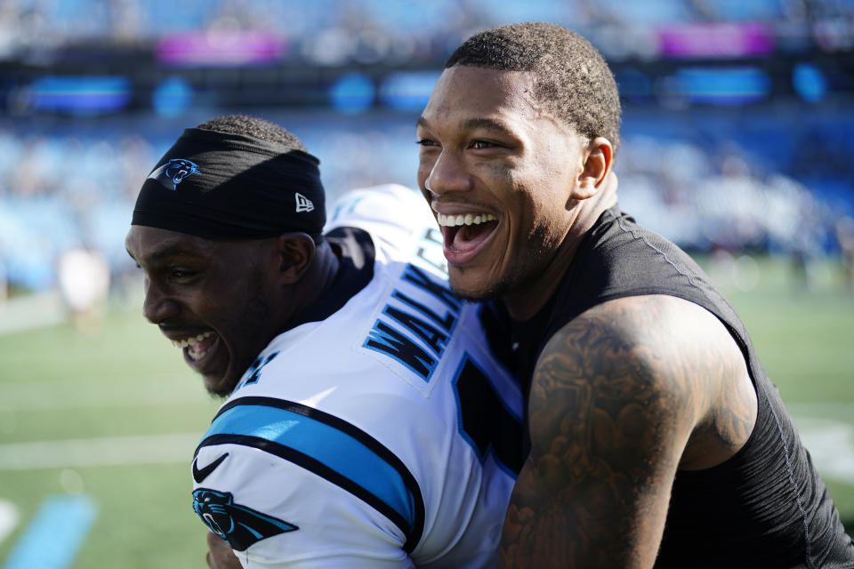 Carolina Panthers wide receiver DJ Moore, right, and quarterback PJ Walker (11) celebrates their 21-3 win over the Tampa Bay Buccaneers after an NFL football game Sunday, Oct. 23, 2022, in Charlotte, N.C. (AP Photo/Jacob Kupferman)