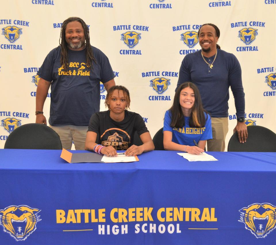 Battle Creek Central track standouts are featured at a signing ceremony at the high school. Seated at left, Samya Fisher has committed to run at Brewton Parker College and Bailey McCulloch has committed to Siena Heights.