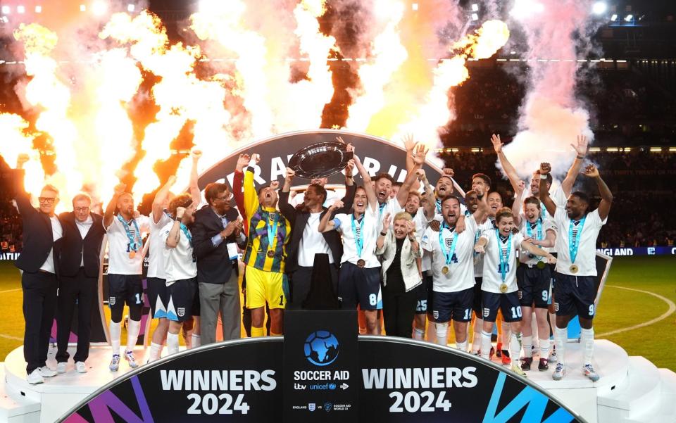 England celebrate with the trophy at Stamford Bridge - England end World XI five-year winning streak in Soccer Aid 2024