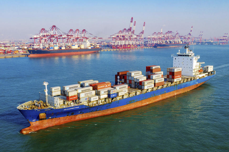 A container vessel moves past the port in Qingdao in eastern China's Shandong province on Tuesday, Jan. 14, 2020. China's exports rose 0.5% in 2019 despite a tariff war with Washington after growth rebounded in December on stronger demand from other markets. (Chinatopix Via AP)