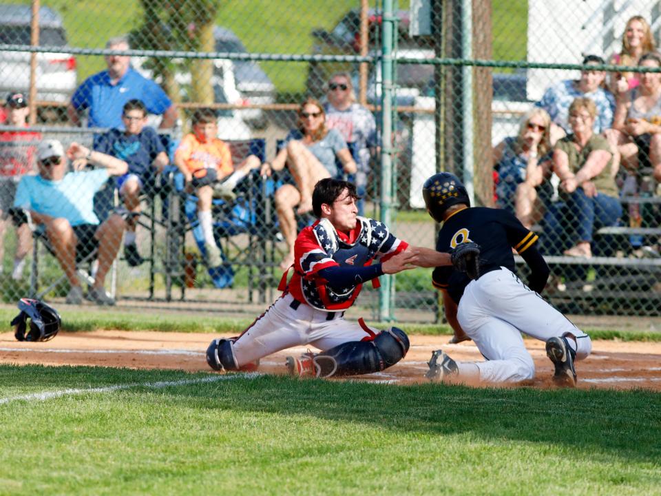 Ryan Lamonica tries to slide around the tag of catcher Tanyon McComb during the first inning of Tri-Valley's 11-4 win against Indian Valley in a Division II district semifinal at Lake Park in Coshocton.