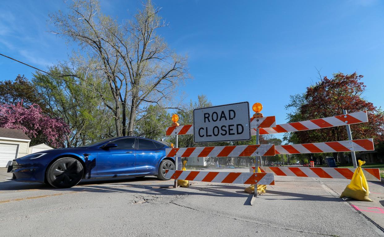 A vehicle drives past a road closure sign on Monday at the intersection of Libal Street and Allouez Avenue in Allouez.