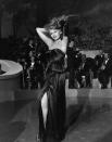 <p>Rita Hayworth's iconic <em>Gilda </em>outfit was made even more glamorous by her diamond tennis necklace. The thin choker was subtle but dazzling, and made a statement against her strapless satin evening gown. </p>