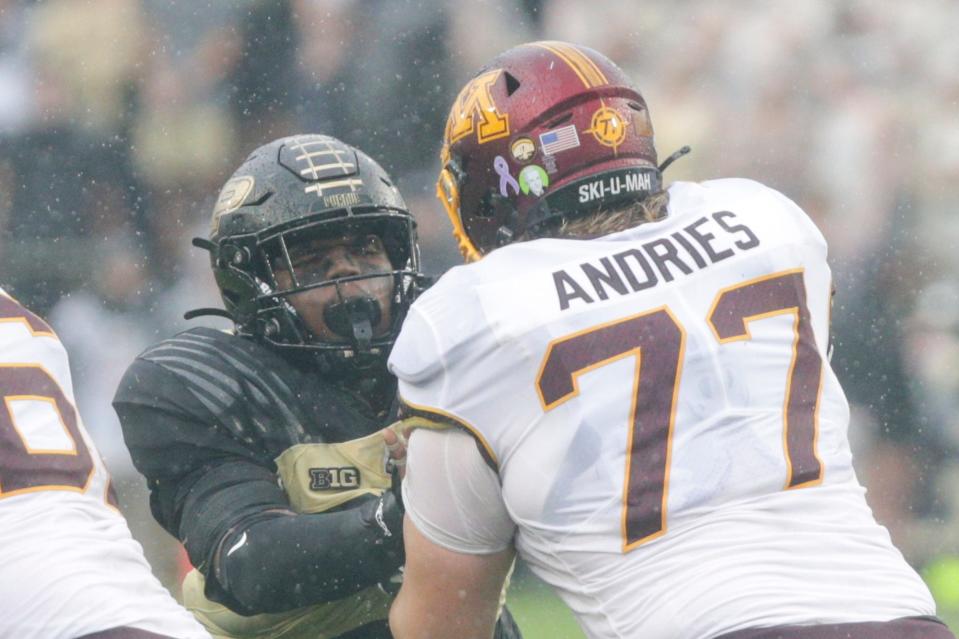 Purdue defensive tackle Lawrence Johnson (90) blocks Minnesota offensive lineman Blaise Andries (77) during the fourth quarter on Oct. 2 at Ross-Ade Stadium in West Lafayette, Ind. Andries is an undrafted free agent signee with the Dolphins.