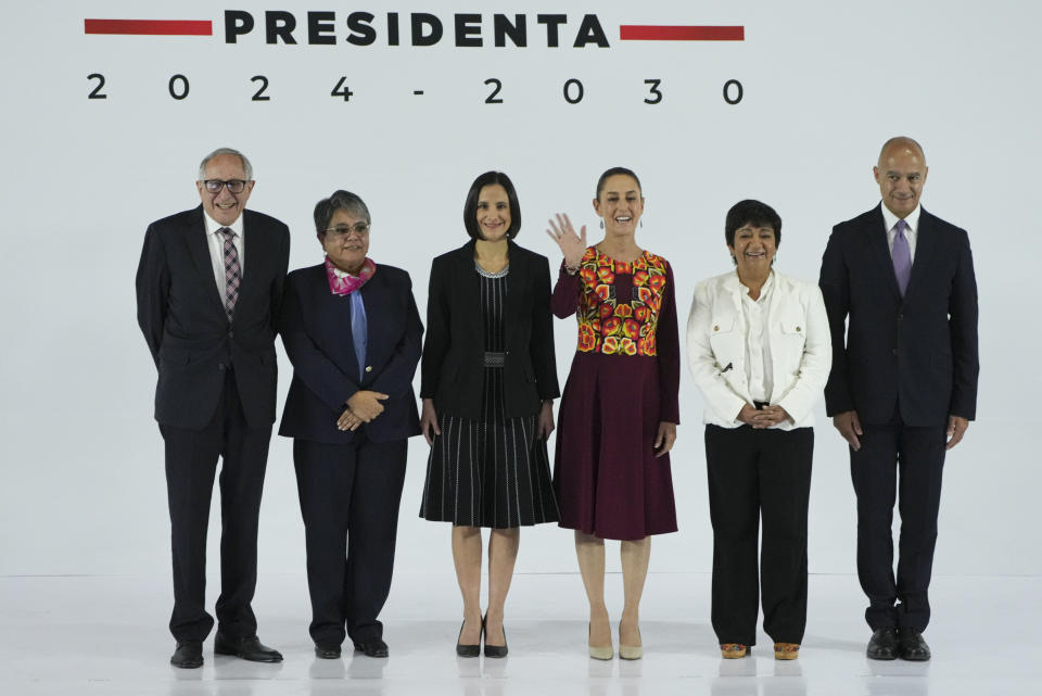 Incoming President Claudia Sheinbaum waves during a press conference where she presented members of her Cabinet in Mexico City, Thursday, June 27, 2024. Pictured from left to right; Health Secretary David Kershenobich, Internal Affairs Secretary Raquel Buenrostro, Energy Secretary Luz Elena Gonzalez, incoming President Claudia Sheinbaum, Agriculture Secretary Edna Elena Vega Rangel and Transport and Communications Secretary Jesus Antonio Esteva Medina. (AP Photo/Fernando Llano)