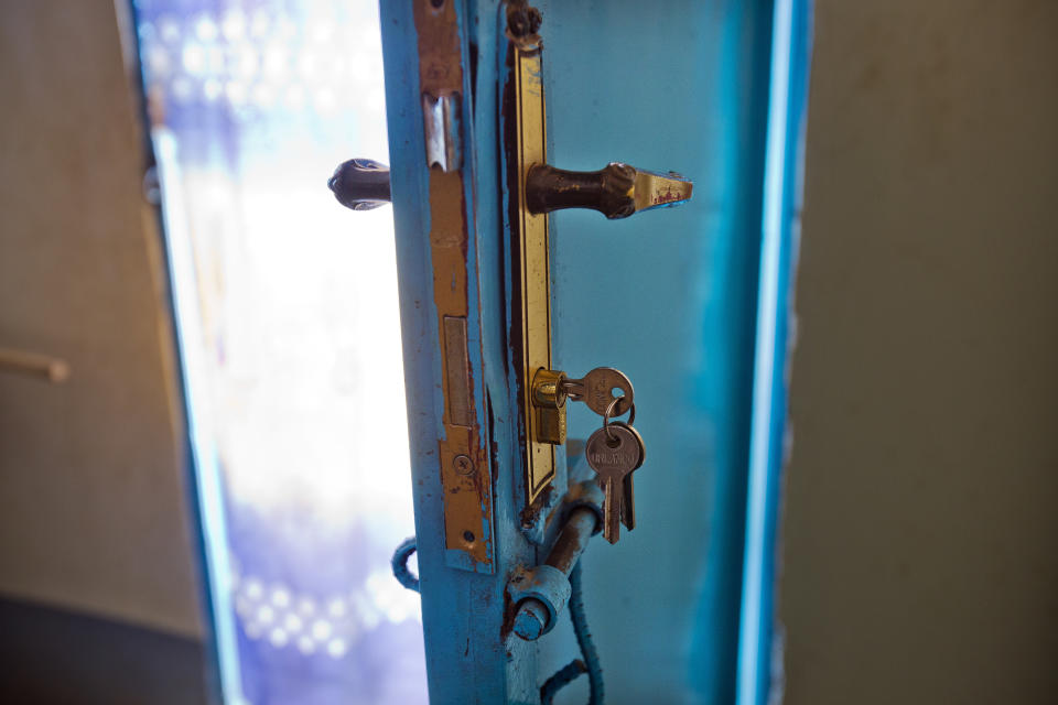 A set of keys hangs from a door lock inside the Masaidizi Health Center in Lubumbashi, Democratic Republic of the Congo on Tuesday, Aug. 14, 2018. An Associated Press investigation focused in Congo's second city, the copper-mining metropolis of Lubumbashi, discovered that of more than 20 hospitals and clinics visited, all but one detain patients unable to pay their bills. The practice is illegal according to the Congolese penal code. (AP Photo/Jerome Delay)