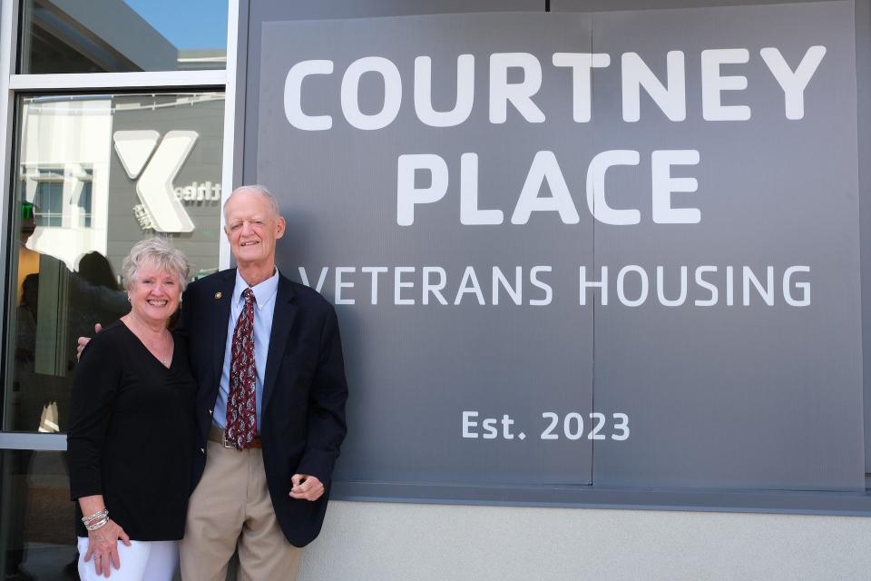 Peter Courtney and his wife, Margie, in front of the sign at Courtney Place, the new downtown Salem affordable housing complex for veterans. Courtney led the effort to find funding for the project.