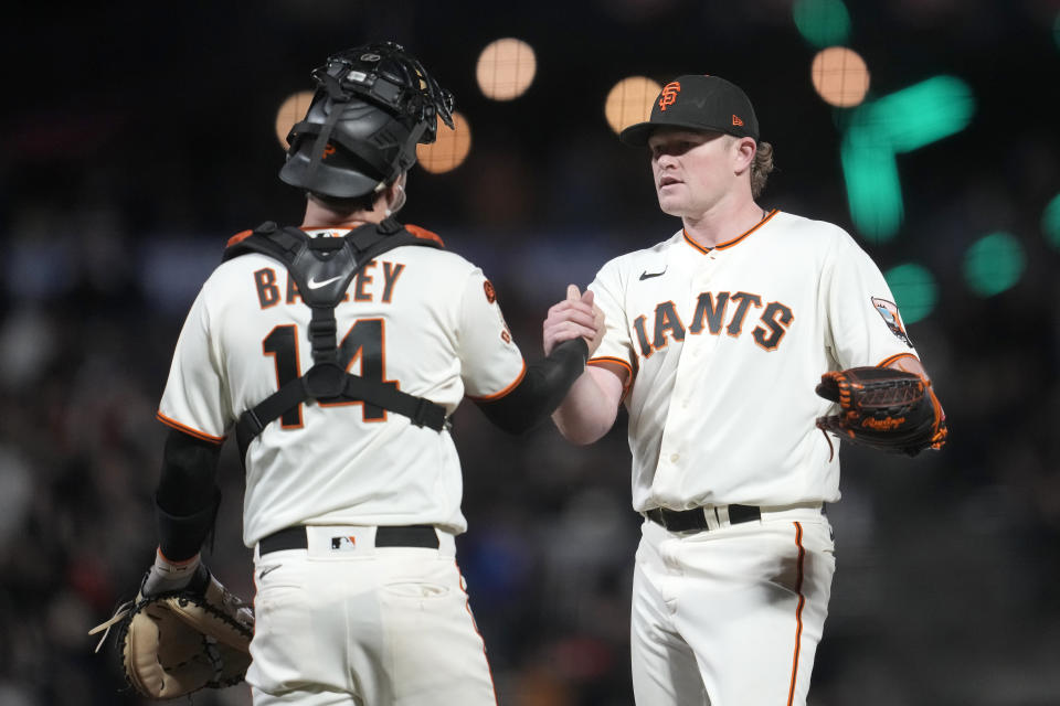 San Francisco Giants catcher Patrick Bailey, left, celebrates with pitcher Logan Webb, right, after they defeated the San Diego Padres in a baseball game in San Francisco, Monday, Sept. 25, 2023. (AP Photo/Jeff Chiu)