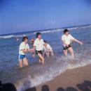 <p>The Beatles splash onlookers at Miami Beach, Florida, in 1964. </p>